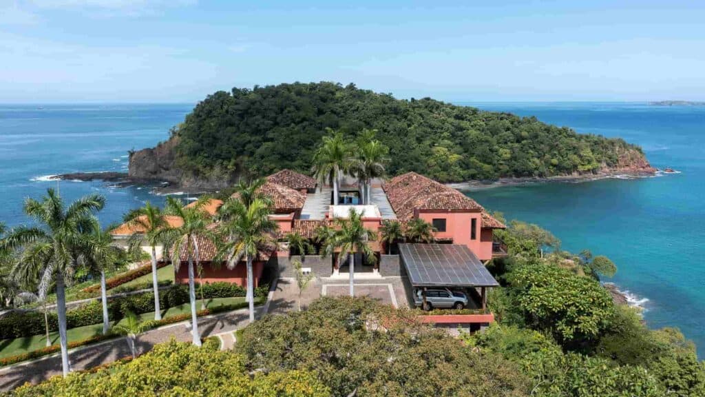 A beautiful beachfront property surrounded by the blue ocean and lush greenery in Costa Rica.