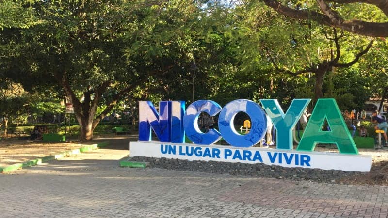 A blue and green sign that says "Nicoya"