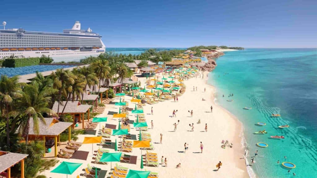 A beach in the Bahamas with blue water, white sand, turquoise and orange umbrellas, and a cruise ship parked in the background.