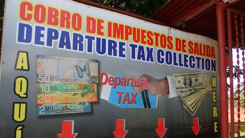 A sign for the Cobro de Impuestos de Salida, Departure Tax Collection, in Costa Rica