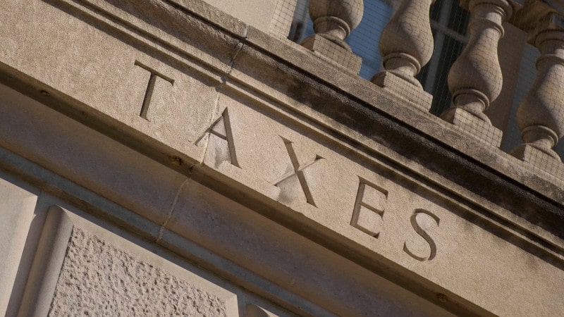 An old building that says "TAXES" in bold letters.