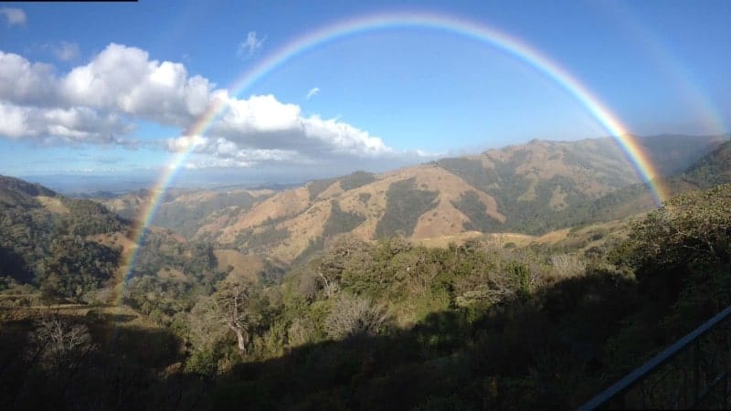 A rainbow stretching across a canyon in Costa Rica.