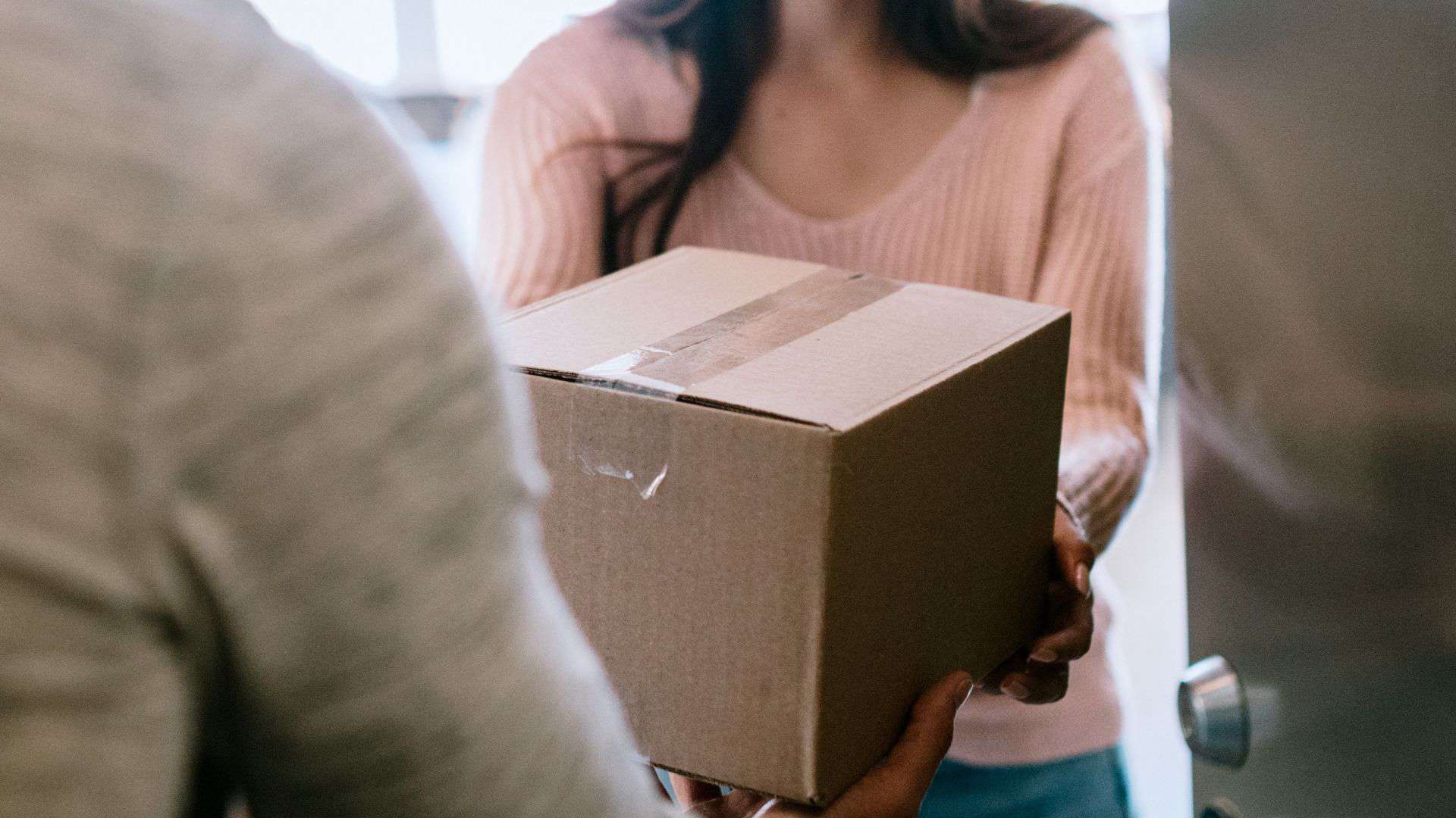a person handing over a box