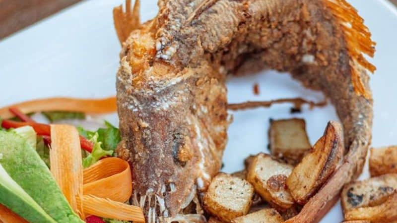 Fried whole butterflied snapper with chimichurri sauce, potatoes and vegetables