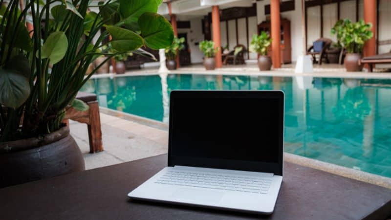 a laptop in front of a pool