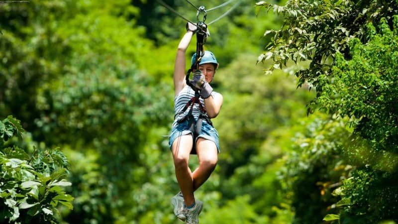 A girl ziplining in the rainforest in Cost Rica.